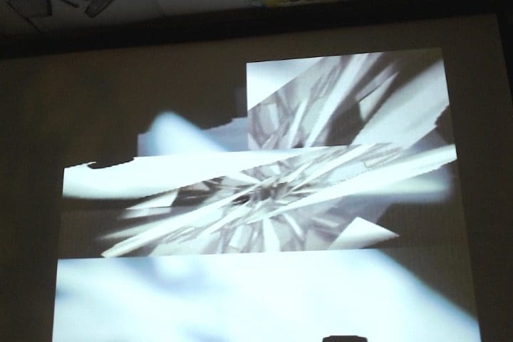 A projector screen with a picture of a flower.